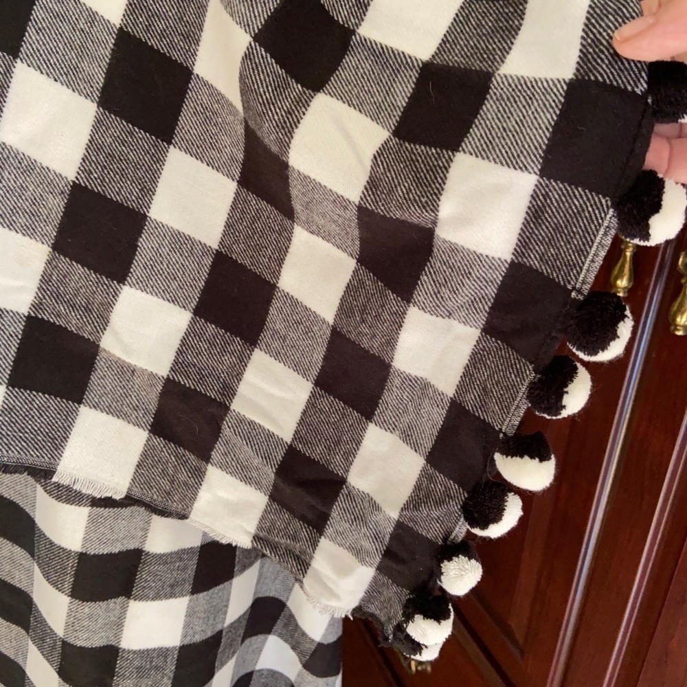 J. Crew shawl with b&w pompoms and a lively check pattern. Super soft flannel.